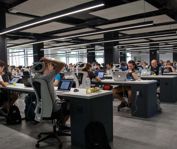 A group of workers working in an office setting